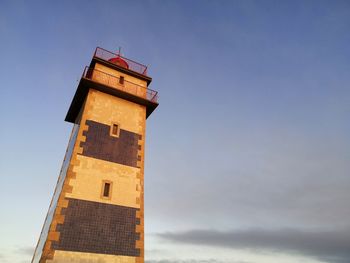 Low angle view of a lighthouse against sky at sunset
