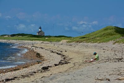 Man on beach against sky