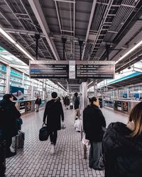 People waiting at railroad station platform