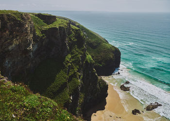 High angle view of rocks on beach against sky near bedruthan steps