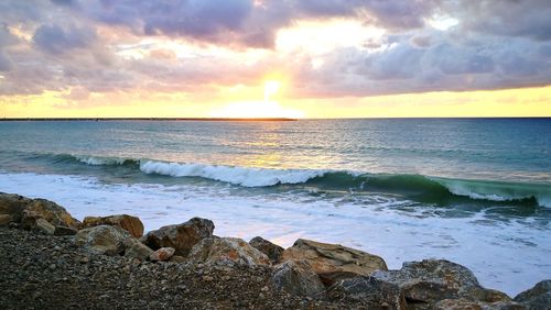 Scenic view of sea against sky during sunset