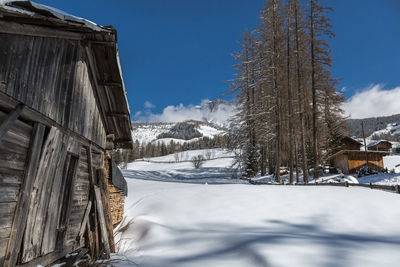 Wooden shack in winter day with fresh snow in the mountains.