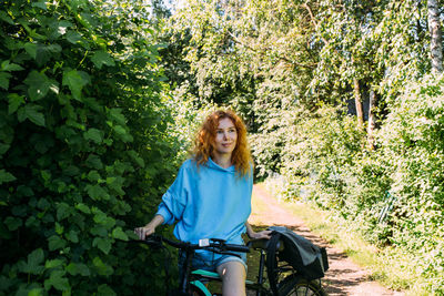 A young woman uses a modern electric bicycle for sports and outdoor recreation