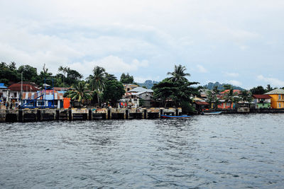 Houses in town against cloudy sky