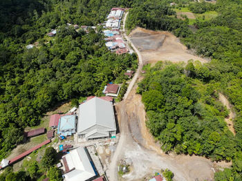 High angle view of houses amidst trees and buildings