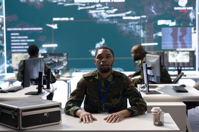 Side view of young man working at airport