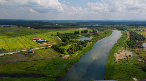 Scenic view of agricultural field against sky