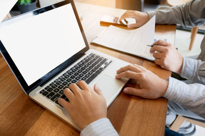 Low section of woman working on table