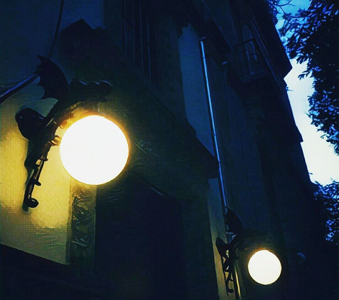 LOW ANGLE VIEW OF ILLUMINATED STREET LIGHT AGAINST SKY