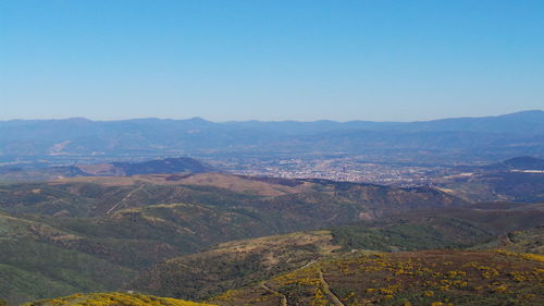 Scenic view of mountain range against blue sky