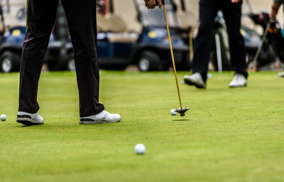 Low section of man playing golf course