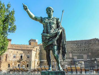 Low angle view of statue against historic building