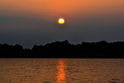 View of calm lake at sunset