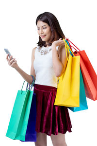 Happy woman holding mobile phone against white background