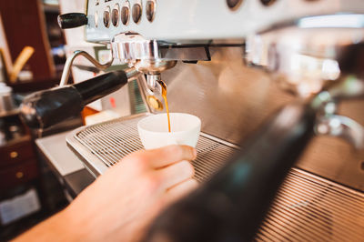 Close-up of coffee being poured in cup at cafe