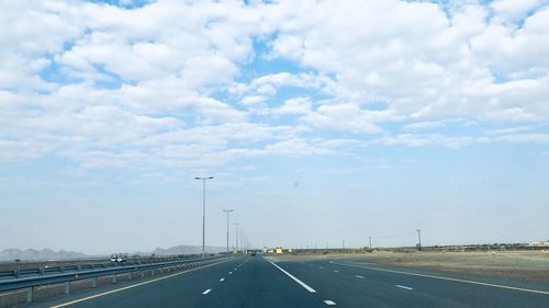 Road by highway against sky