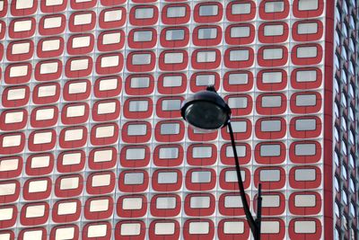 Low angle view of telephone booth against wall