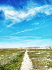 Empty road along countryside landscape