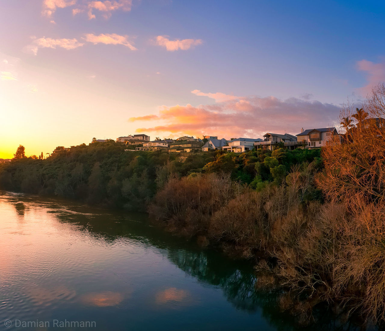 SCENIC VIEW OF RIVER BY TREES AGAINST SKY AT SUNSET