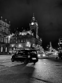 Cars moving on road in city at night