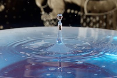 Close-up of drop splashing on water