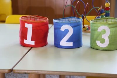 Containers with numbers on table 