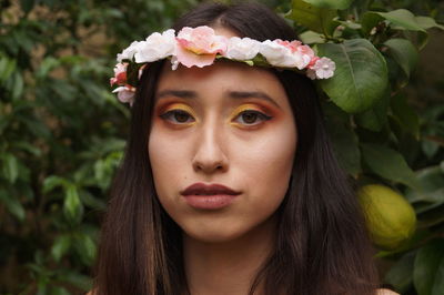 Close-up portrait of woman wearing flowers