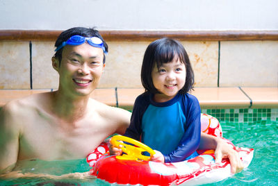 Happy family in swimming pool