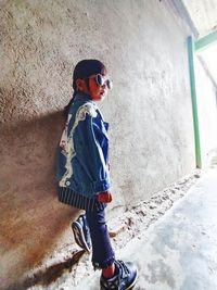 Boy standing against wall