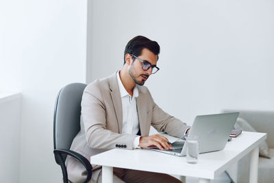 Young businesswoman using laptop while sitting at home