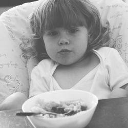 Portrait of cute girl sitting in bowl