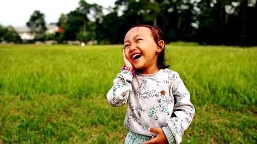 Portrait of cute girl standing on field