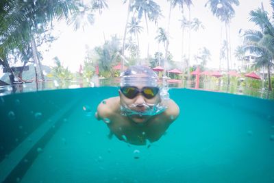 Portrait of man swimming in pool