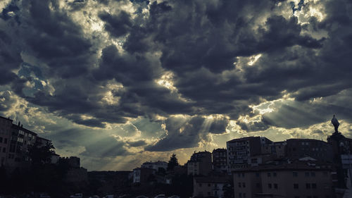 Buildings against cloudy sky