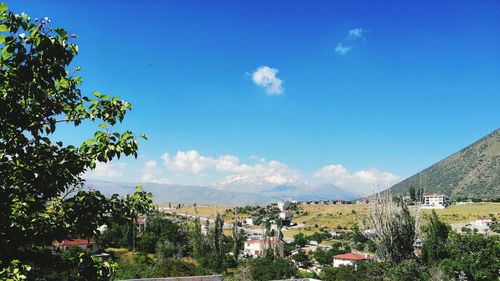 View of townscape against blue sky