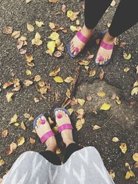 Low section of women standing on street