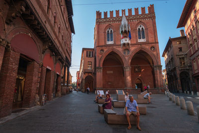 People in front of buildings in city