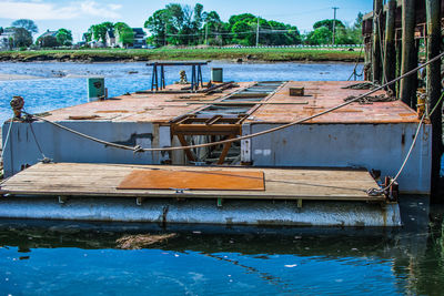 Boat moored in lake against sky