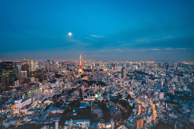 High angle view of illuminated city buildings against sky