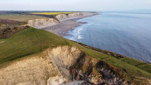 High angle view of land and sea against sky