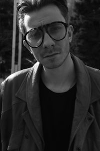 Portrait of young man wearing sunglasses standing outdoors