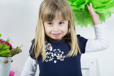 Portrait of cute girl holding artificial flower