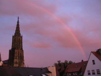 Low angle view of rainbow over buildings in city