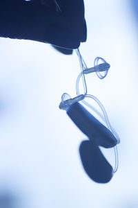 Close-up of shoes hanging against white background