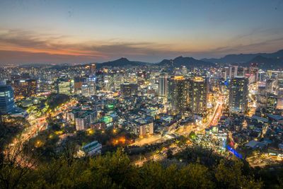 High angle view of illuminated city buildings at night