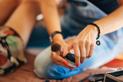 Midsection of woman holding make-up