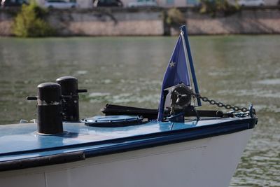 Close-up of sailboats moored on lake