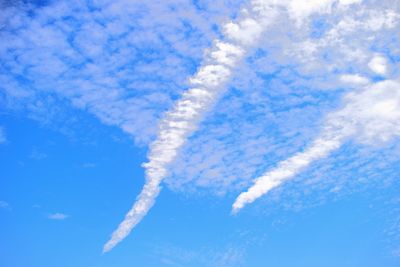 Low angle view of vapor trail against blue sky