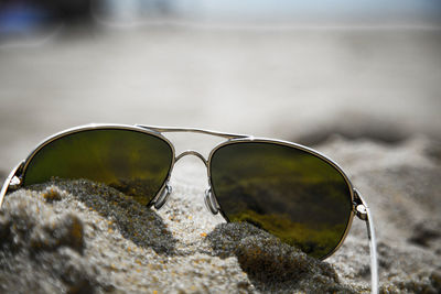 Close-up of sunglasses against sky