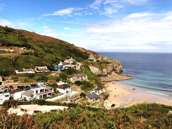 High angle view of townscape by sea against sky